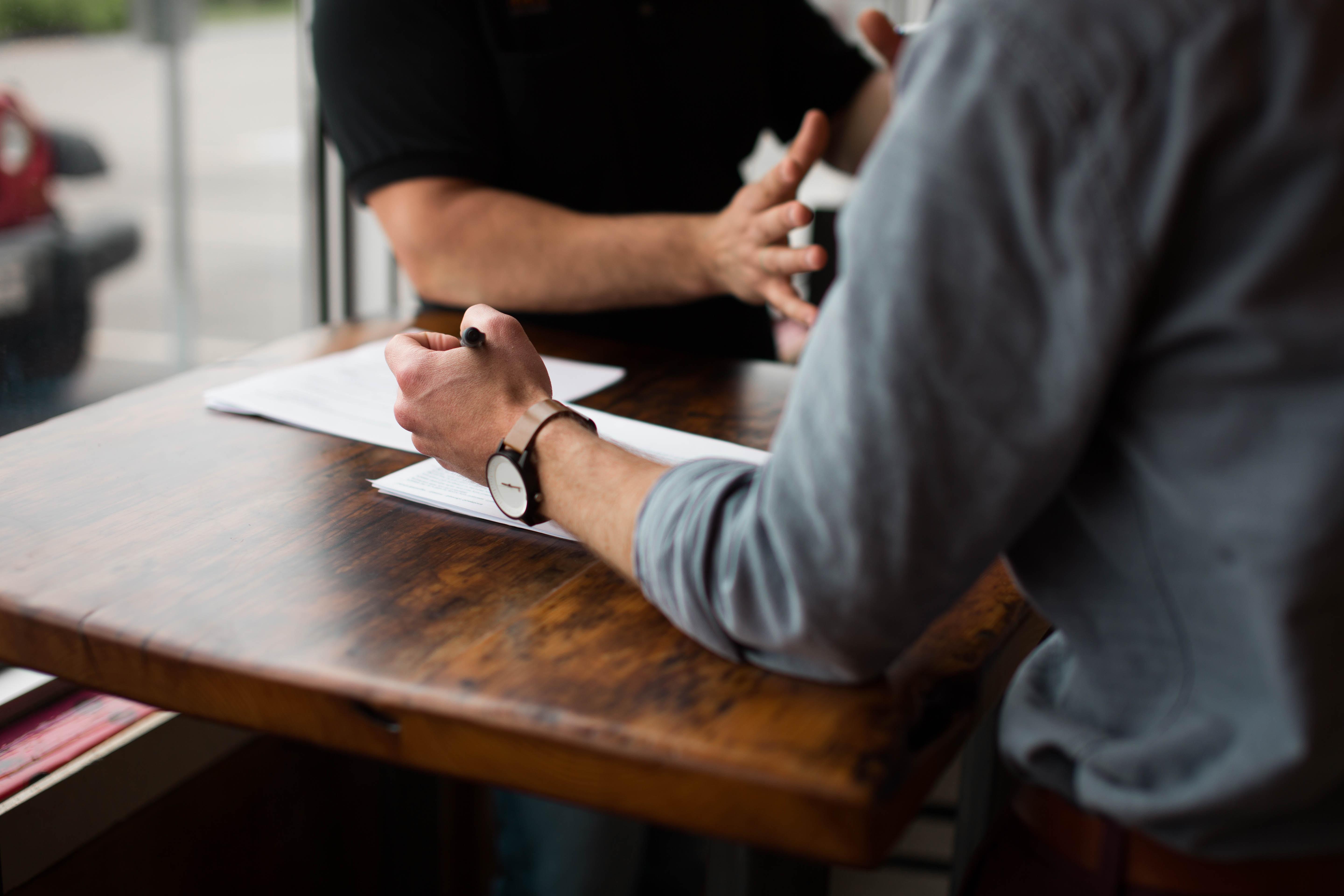 Man sitting at table reviewing a paper